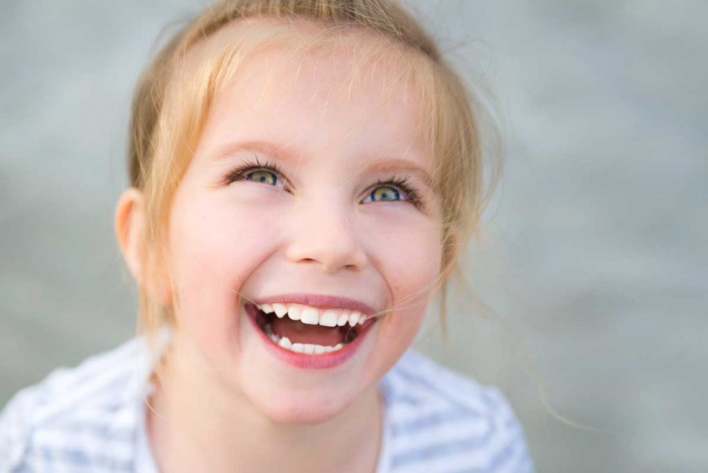 Young girl showing off her smile while doing early orthodontic treatment for pediatric patients in Los Angeles, CA
