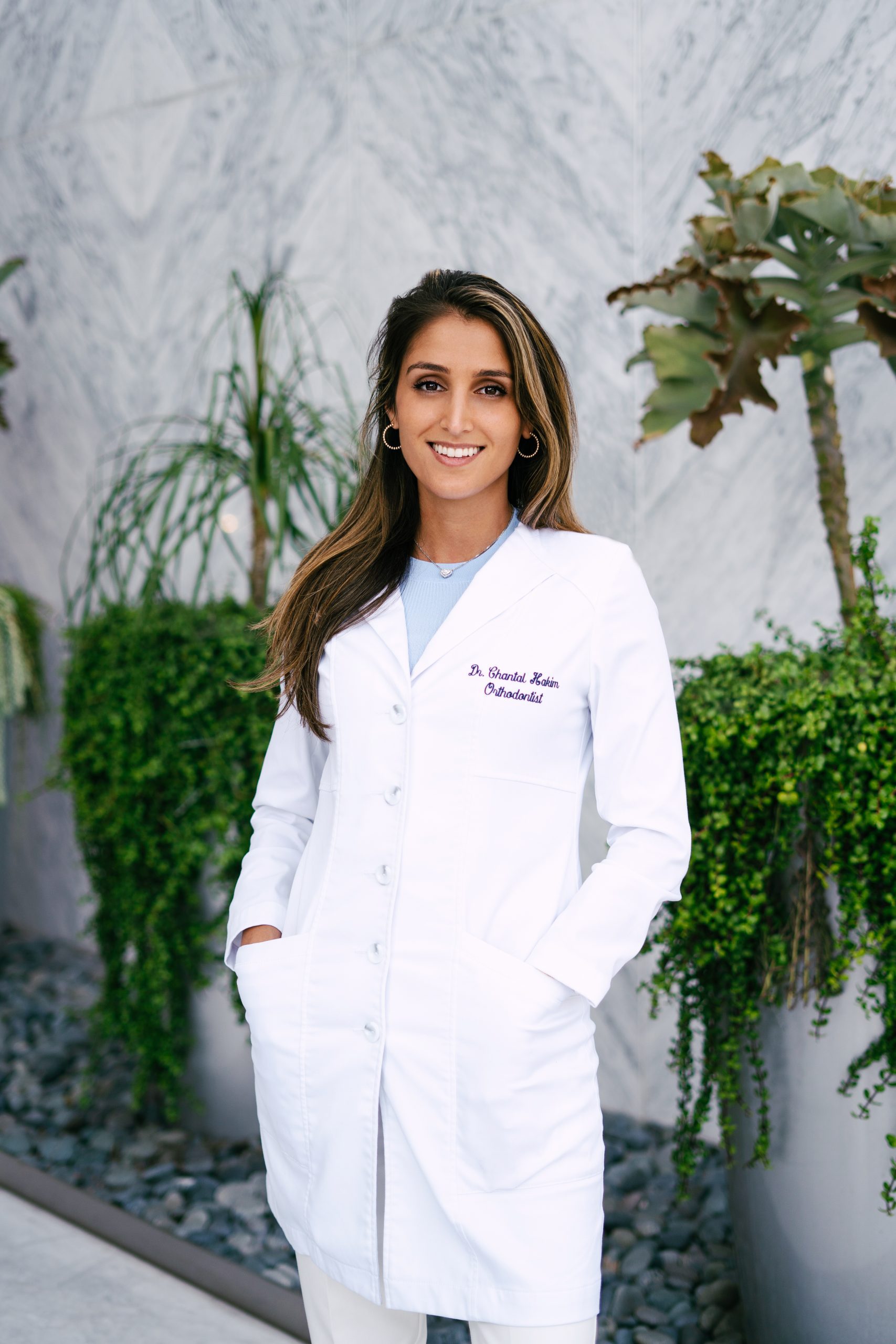 Dr Chantal Hakim, the best orthodontist in Los Angeles, standing outside her orthodontic office 