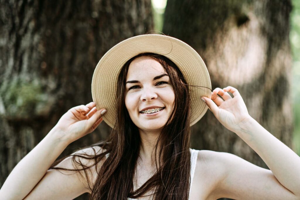 smiling young woman with braces on teeth in Los Angeles Teeth Braces in Los Angeles | Orthospaceship