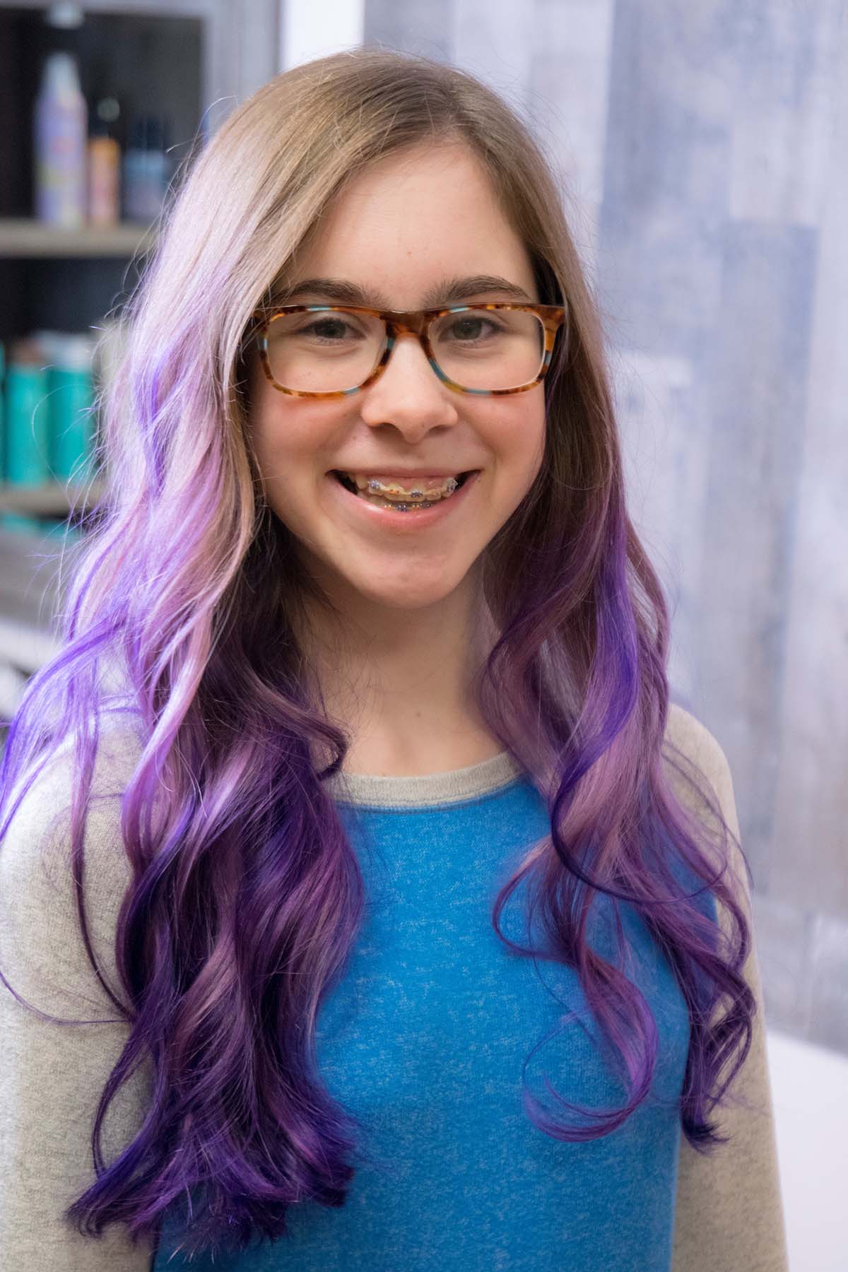 Orthodontic treatment using clear braces for teens on this young girl with purple hair