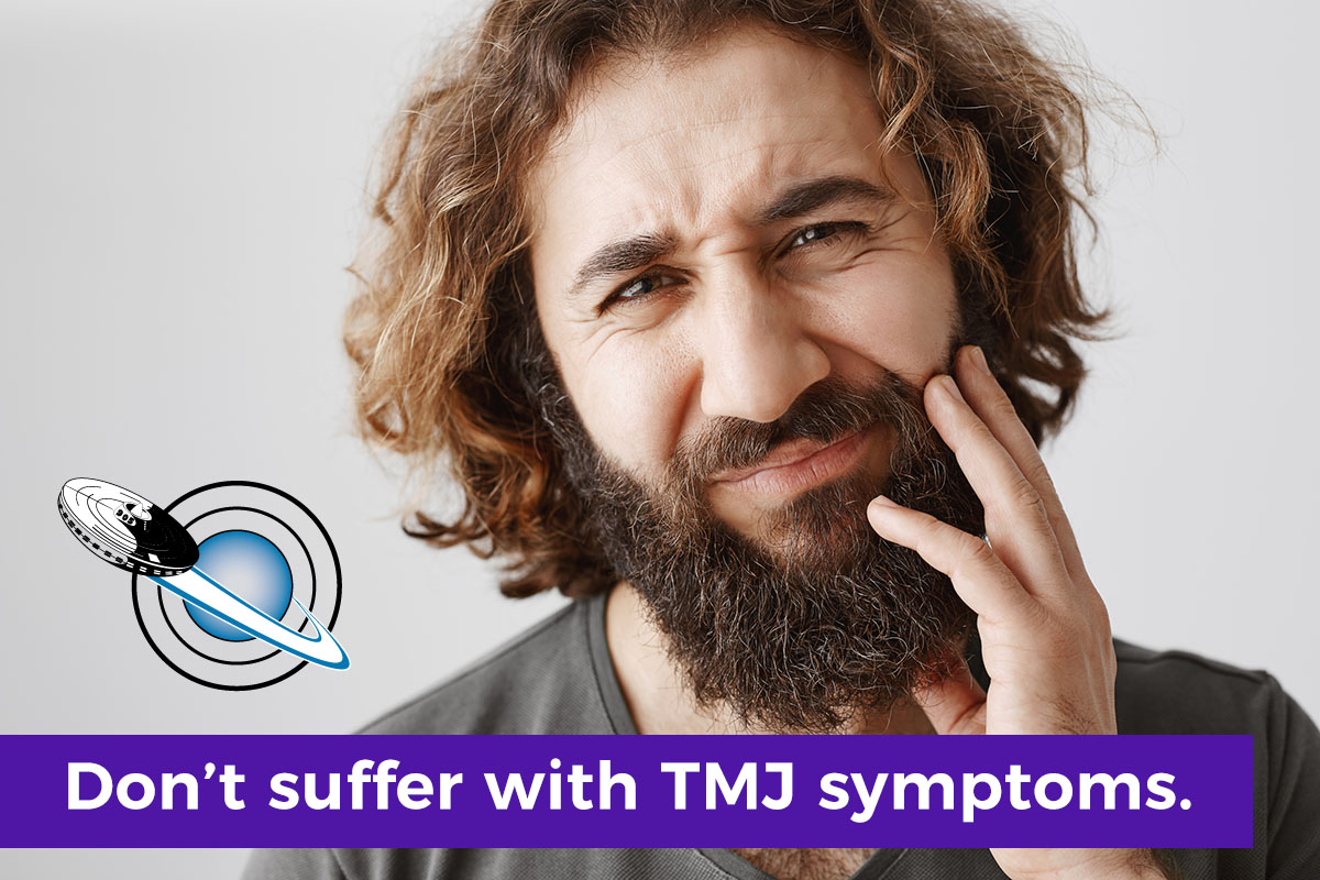 Los Angeles man with TMJ symptoms holding his jaw as he seeks TMJ treatment Los Angeles from Dr. Hakim at the Orthospaceship.