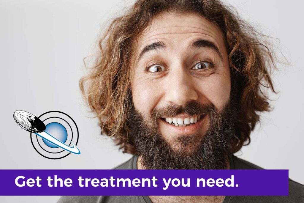 Bearded man smiling after experiencing jaw pain relief from TMJ treatment