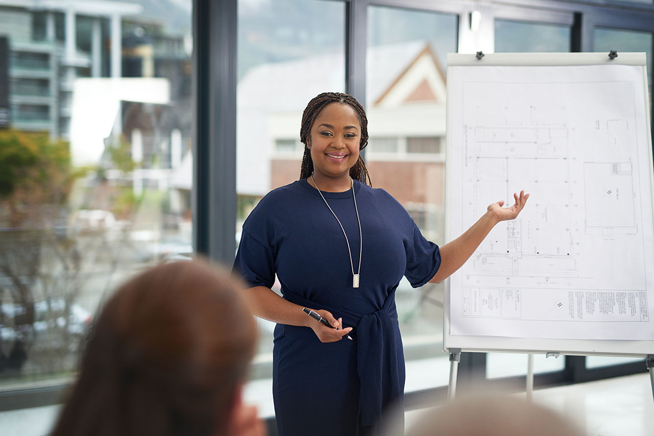 Lingual braces may cost a bit more than traditional braces or clear aligners due to being highly customized Woman confidently smiles while leading a meeting